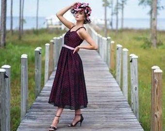 1950's style dress with dark pink underlayer under black lace with fitted bodice and full skirt