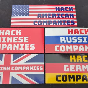May include: Five rectangular stickers with flags and text. The stickers read "Hack American Companies", "Hack Chinese Companies", "Hack British Companies", "Hack Russian Companies", and "Hack German Companies".