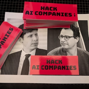 May include: Stacks of red rectangular stickers with the text "HACK AI COMPANIES" in black, are arranged around a black and white image of two men. The stickers are glossy and the text is bold.