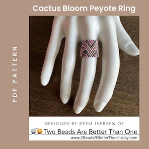 May include: A pink, black, and silver peyote stitch ring. The ring is on a mannequin hand. The image includes the text "Cactus Bloom Peyote Ring" and "Two Beads Are Better Than One".