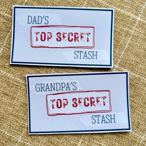May include: Two white cards with blue borders, each with the text "TOP SECRET" in a red stamp. The top card says "DAD'S STASH" and the bottom card says "GRANDPA'S STASH".