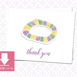 May include: A white thank you card with a purple, green, and yellow watercolor illustration of a Mardi Gras necklace. The text "thank you" is written in purple below the illustration.