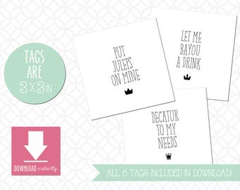 May include: A collection of white square tags with black text, including phrases like "Put Juleps on Mine" and "Let Me Bayou a Drink." A green circle indicates the tags are 3x3 inches. A pink square with a downward arrow and the words "Download instantly" is also present.