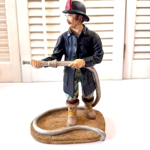 Vintage Albert E Price Fireman Figurine  “Fireman Nozzleman” 1989 AEP Inc ~ Fireman with Hose ~ 9” tall