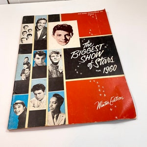 May include: A red and black magazine cover with the title "The Biggest Show of Stars for 1960" and the words "Winter Edition". The cover features photos of various singers and actors.