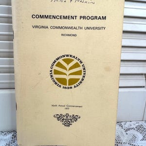 May include: A tan-colored program booklet for the 1977 commencement ceremony at Virginia Commonwealth University in Richmond. The cover features the university's seal in gold and black, with the text "Virginia Commonwealth University 1838" around the seal.