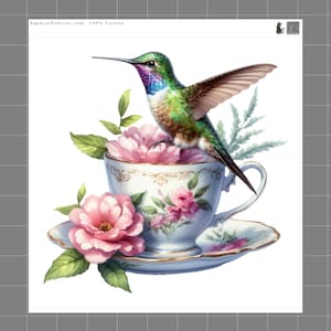 May include: A hummingbird with green, purple, and white feathers perched on a light blue teacup and saucer decorated with pink flowers and gold trim. The text SaphiesFabrics.com 100% Cotton is visible at the top left corner of the fabric panel.