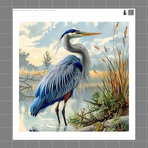 May include: A 100% cotton fabric panel featuring a blue heron standing in shallow water near tall grasses. The scene includes a cloudy sky and a distant landscape. The text SaphiesFabrics.com 100% Cotton is printed at the top of the white border.