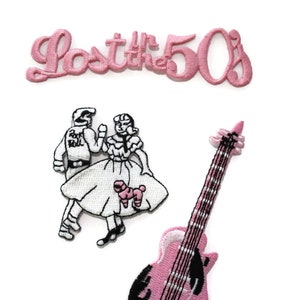 May include: Three pink embroidered iron-on patches. One patch says "Lost the 50s". Another patch shows a couple dancing. The third patch is a pink and black electric guitar.