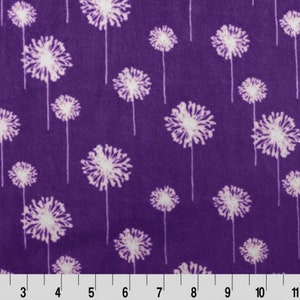 May include: Purple fabric with a white dandelion pattern. The fabric is soft and has a subtle sheen.