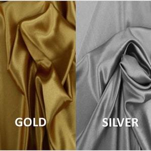 May include: Two swatches of fabric, one gold and one silver, showing the texture and drape of the material.