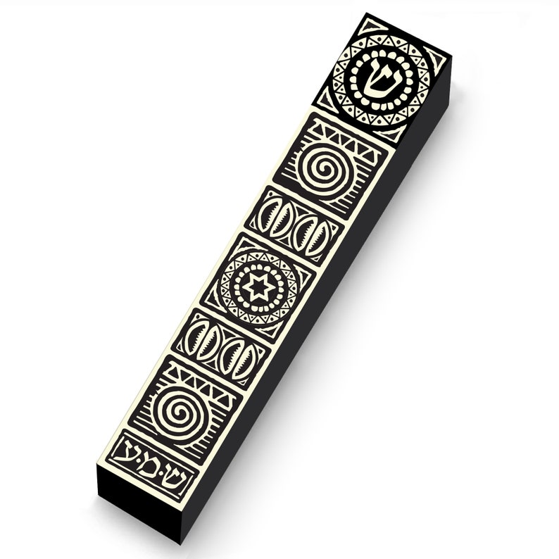 May include: A black rectangular object with cream-colored geometric designs. The designs include a spiral, a six-pointed star, and other patterns. The top of the object has a Hebrew letter. The object is on a white background.