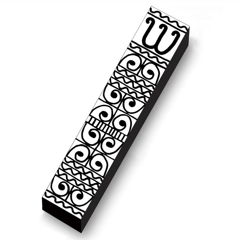 May include: A rectangular, black and white decorative object with a series of repeating patterns. The patterns include swirls, wavy lines, and a stylized letter "W". The object is angled, casting a shadow on the white background.