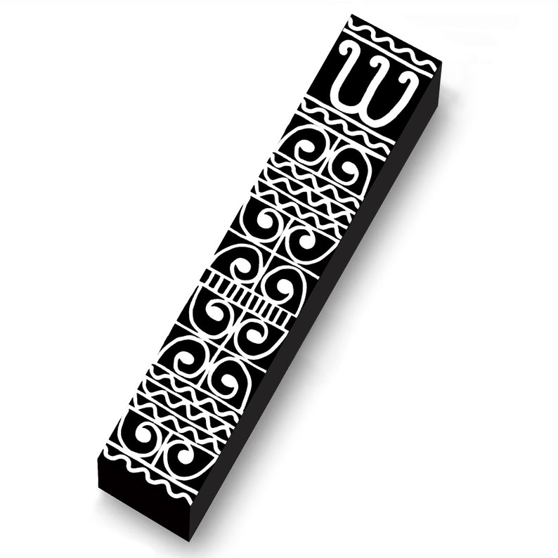 May include: A black rectangular object with white decorative patterns and the letter "W" at the top. The design includes swirls, zigzags, and lines. The object is angled, casting a shadow on a white background.