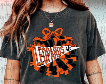 May include: Dark gray t-shirt featuring a graphic of a cheerleading pom-pom with a bow and the word "LEOPARDS" in orange and white. A paw print is on the white pennant. The design is in orange, black, and white.
