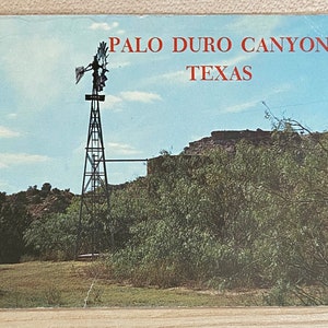 May include: A vintage postcard featuring a black windmill against a blue sky with white clouds. The postcard reads "Palo Duro Canyon, Texas".