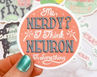 May include: A round sticker with a pink background and white stars. The text "Me, Nerdy? I think Neuron to something" is written in gray and white lettering. A stylized neuron is illustrated on the sticker.
