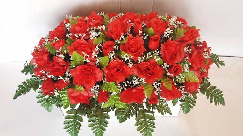 Large Red rose Memorial saddle with baby/'s breath and greenery.