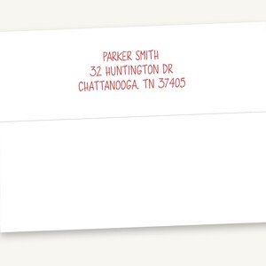 May include: A white rectangular envelope featuring red printed text on the back flap. The text reads: PARKER SMITH, 32 HUNTINGTON DR, CHATTANOOGA, TN 37405. The envelope is closed with a horizontal flap across the upper portion of the paper surface.