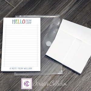 May include: A white notepad with lined paper and a colorful "Hello from Camp" header. The notepad has a space at the bottom for a personalized message, which reads "A note from William".