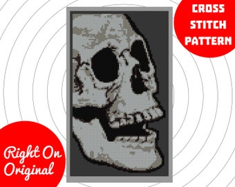 May include: Cross stitch pattern of a detailed gray and black skull with an open mouth. The skull is facing to the right and is set against a dark gray background.