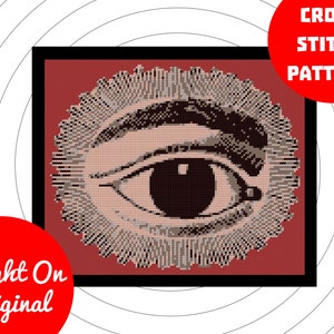 May include: Cross stitch pattern of a large eye with a brown eyebrow and eyelashes. The eye is surrounded by a brown and white circular design. The background is a dark red color.