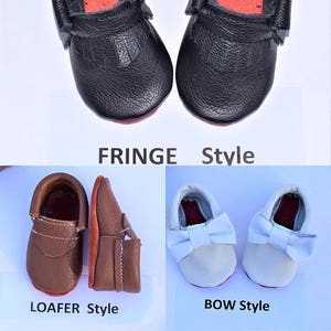 May include: A collection of baby shoes in various styles. The image showcases black fringe-style shoes, brown loafer-style shoes, and white bow-style shoes. The shoes have red soles and are made of leather.