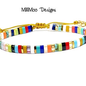 May include: Multicolored beaded bracelet with a gold clasp and adjustable cord. The bracelet features a variety of colors, including red, blue, green, yellow, and white.