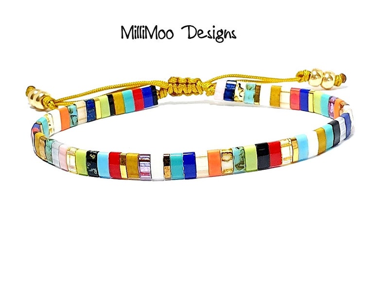May include: Multicolored beaded bracelet with a gold clasp and adjustable cord. The bracelet features a variety of colors, including red, blue, green, yellow, and white.