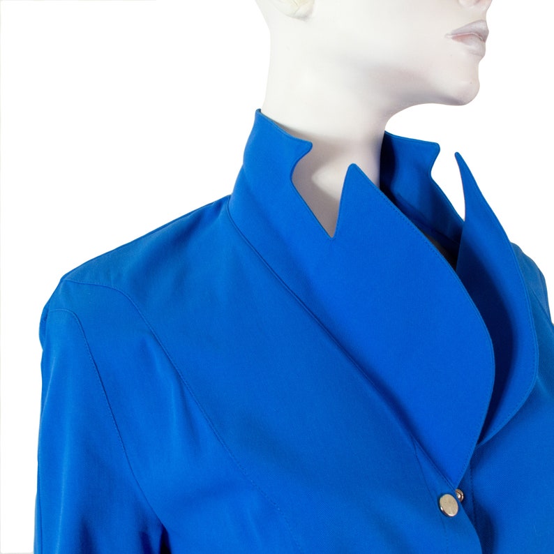 May include: A bright blue blazer with a unique, asymmetrical collar and a single button closure.