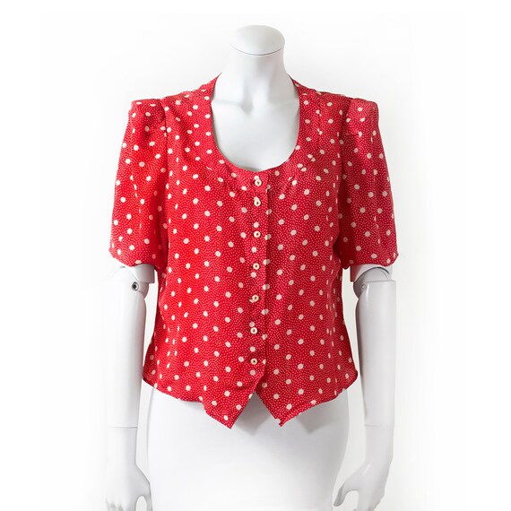 CACHAREL shoulder blouse, red background, white do