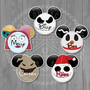 May include: A collection of five stickers featuring characters from "The Nightmare Before Christmas" in a Mickey Mouse ear design. Each sticker has a different character name: Billy, Molly, Ben, Carson, and Ross. The stickers are on a gray wooden background.