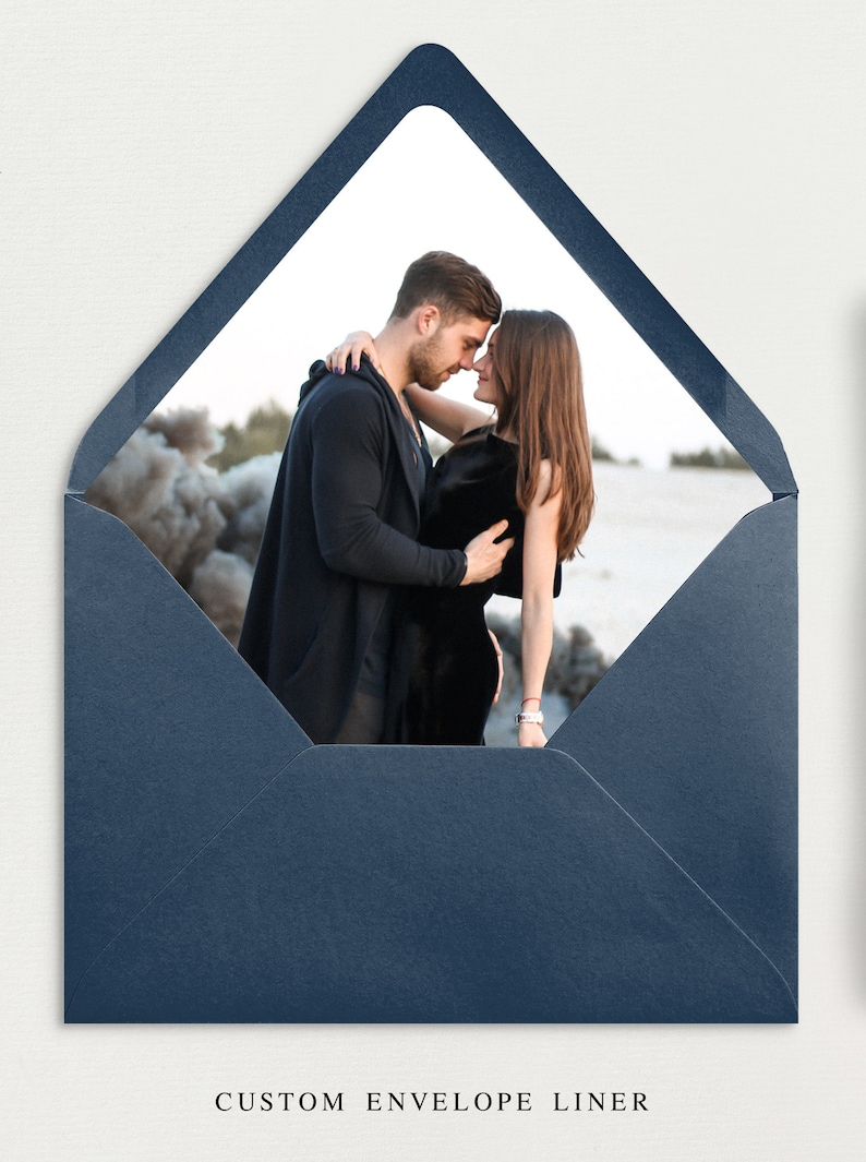 May include: A navy blue envelope liner with a white window showing a couple embracing in front of a beach scene.