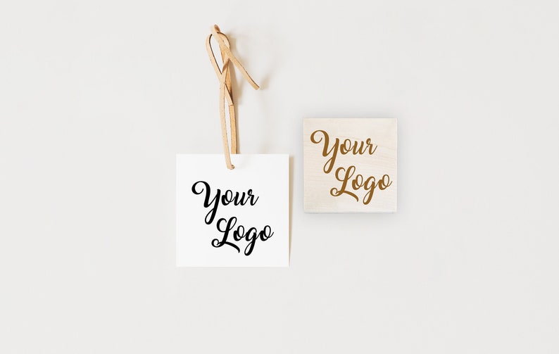 May include: Two square wooden stamps with the text "Your Logo" in a cursive font. The stamp on the left is white with black text. The stamp on the right is natural wood with brown text.