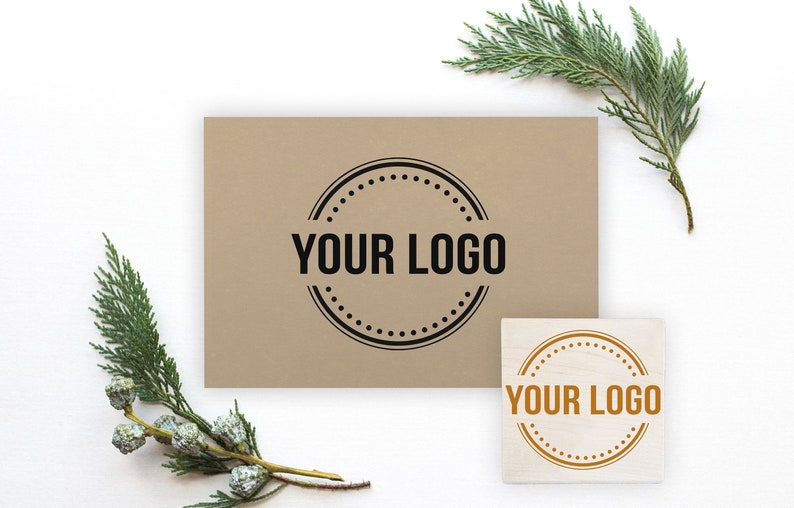 May include: Two brown and white wooden stamps with a circular design. The stamps have the text "YOUR LOGO" in black and gold lettering.
