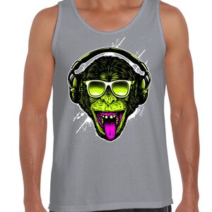 May include: A grey tank top featuring a green monkey wearing sunglasses and headphones. The monkey has a pink tongue sticking out.