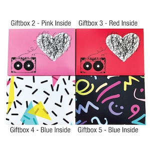 May include: Four gift boxes with different designs. The top two boxes have a pink and red background with a heart and a cassette tape. The bottom two boxes have a white and black background with geometric shapes.