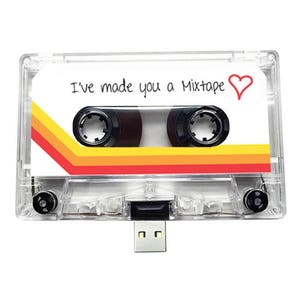 May include: Clear cassette tape USB drive with the text "I've made you a Mixtape" and a red heart. The tape has a retro design with orange, yellow, and red stripes. The USB connector is silver.