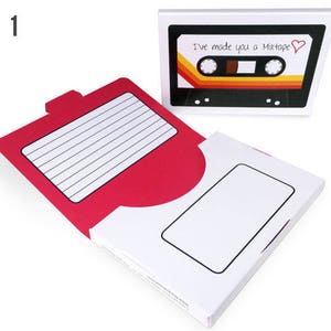 May include: A white box with a red interior and a cassette tape design that reads "I've made you a Mixtape" with a heart. The box is open, revealing a lined paper area and a blank rectangle.