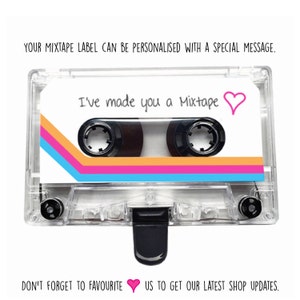 May include: A clear plastic cassette tape with a white label. The label has a pink, orange, and blue striped design. The text on the label reads "I've made you a Mixtape" with a pink heart.