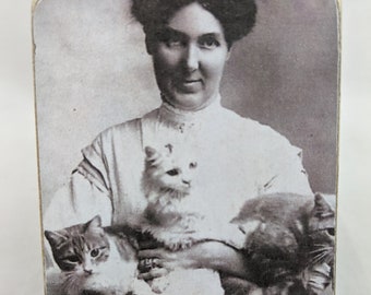May include: A black and white photo of a woman holding two cats. The photo is on a wooden background with the text "You Say "Crazy Cat Lady" Like it's a bad thing."
