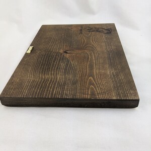 May include: A dark brown wooden sign with a gold metal hanger. The sign has a light brown wood grain pattern and the text "Established 1987" is engraved on the top right corner.