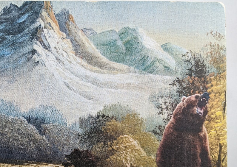 May include: A brown bear with its mouth open roaring in a mountain landscape. The bear is in the foreground of the image, with a snowy mountain range in the background.