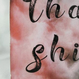 May include: Close-up of a pink and white watercolor background with black calligraphy that reads "Let your light shine". The text "TatzDecoArt" is visible in the bottom right corner.