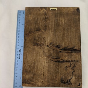 May include: A dark brown wooden sign with a burnt-in image of a deer and the text "TatzDecoArt".