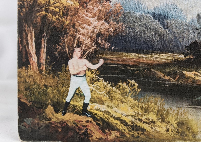 May include: A painting of a man in a boxing stance, wearing white pants and black boots. He is standing on a rocky hill in a forest setting with a river in the background.