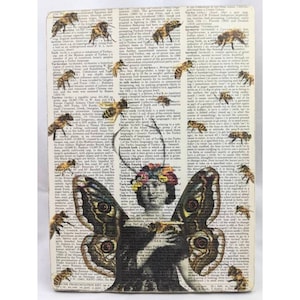 May include: A vintage book page with a butterfly illustration. The butterfly has brown and black wings with a floral crown on its head. The background is a page from a dictionary with the word "Turkey" highlighted.