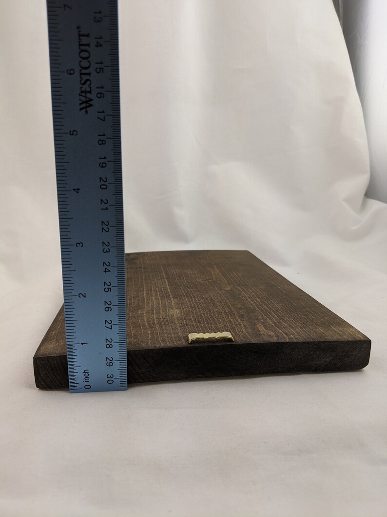 May include: A dark brown wooden sign with a gold metal hanging bracket. The sign is approximately 29 inches long.