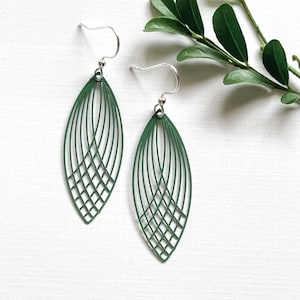 May include: A pair of green geometric earrings with a delicate wire design. The earrings are shaped like a leaf and have a silver hook.