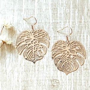 Rose gold Monstera leaf earrings. This quirky pair of statement earrings in the leaf shape of the swiss cheese plant is a perfect, fun gift